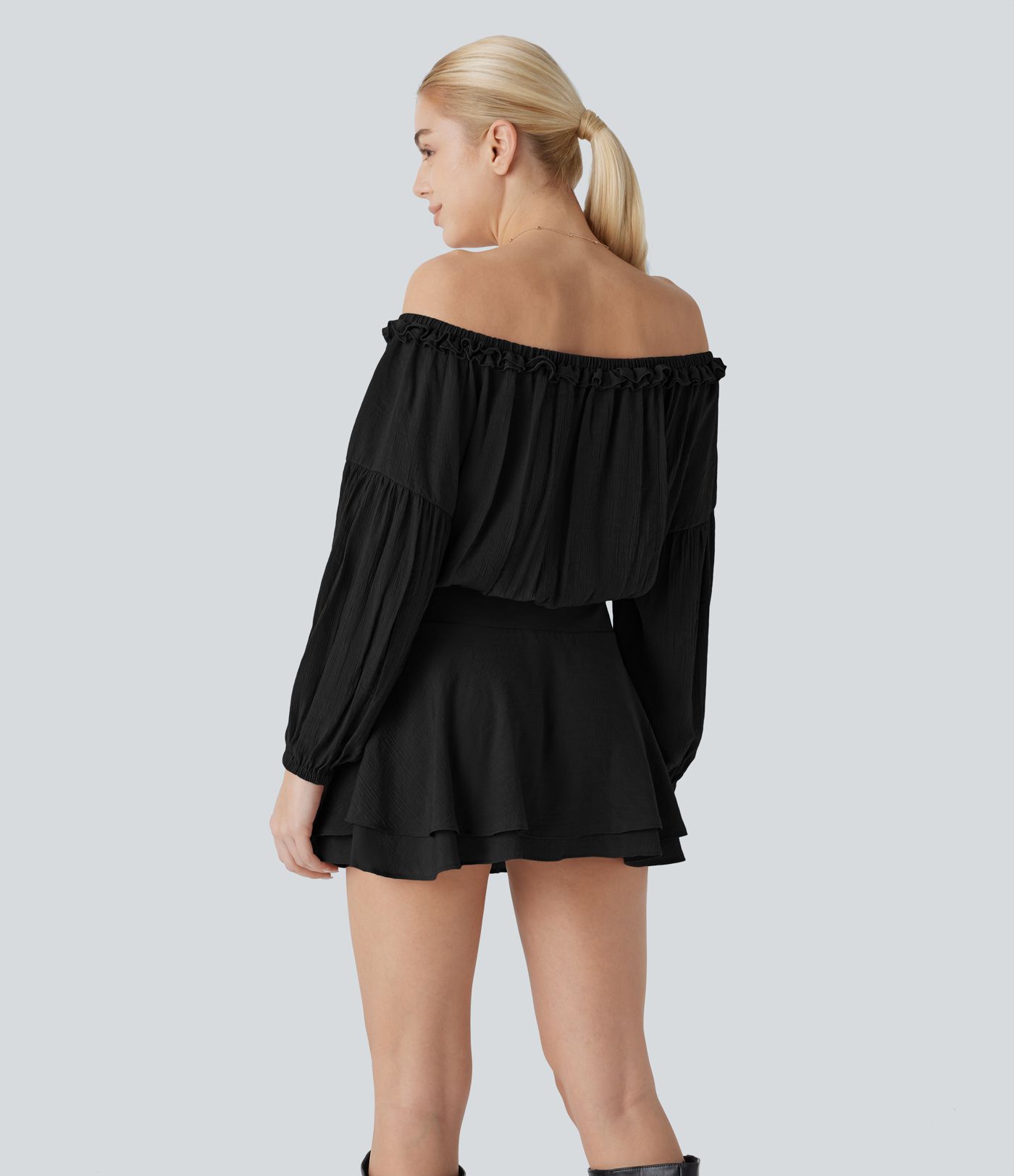 Mini-robe en dentelle à épaules dénudées, manches longues, avec détails en ruban et jupe à plusieurs couches.