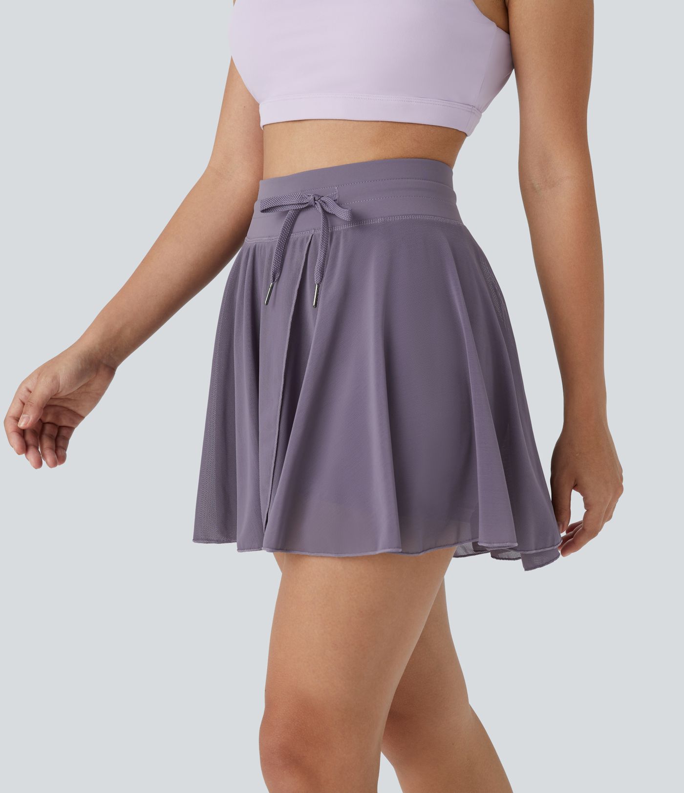 Falda mini acampanada fluida bolsillo lateral 2 en 1 malla contrastante cordón tiro alto