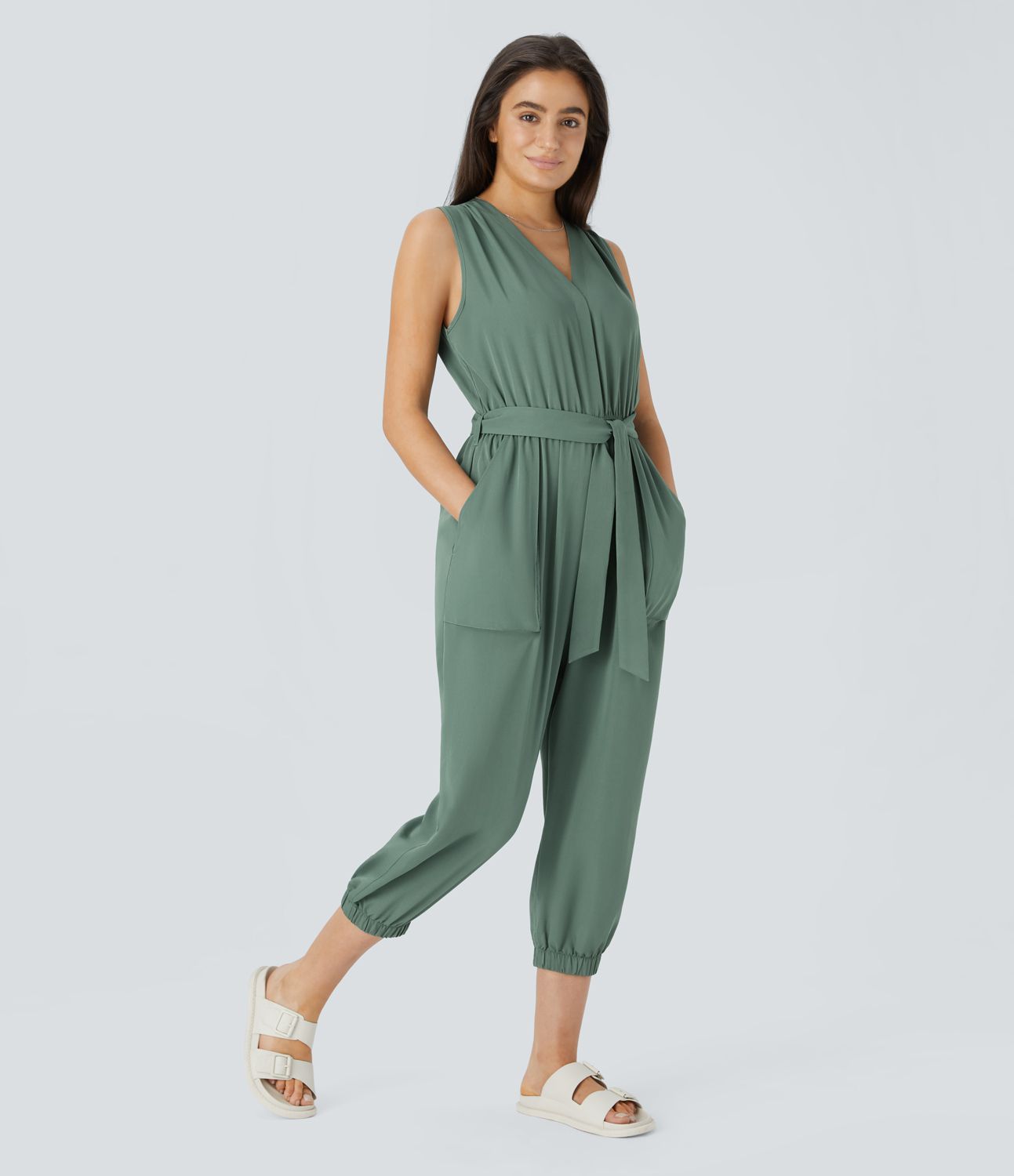V-neck sleeveless zipper belted jumpsuit with side pocket details in a casual style.