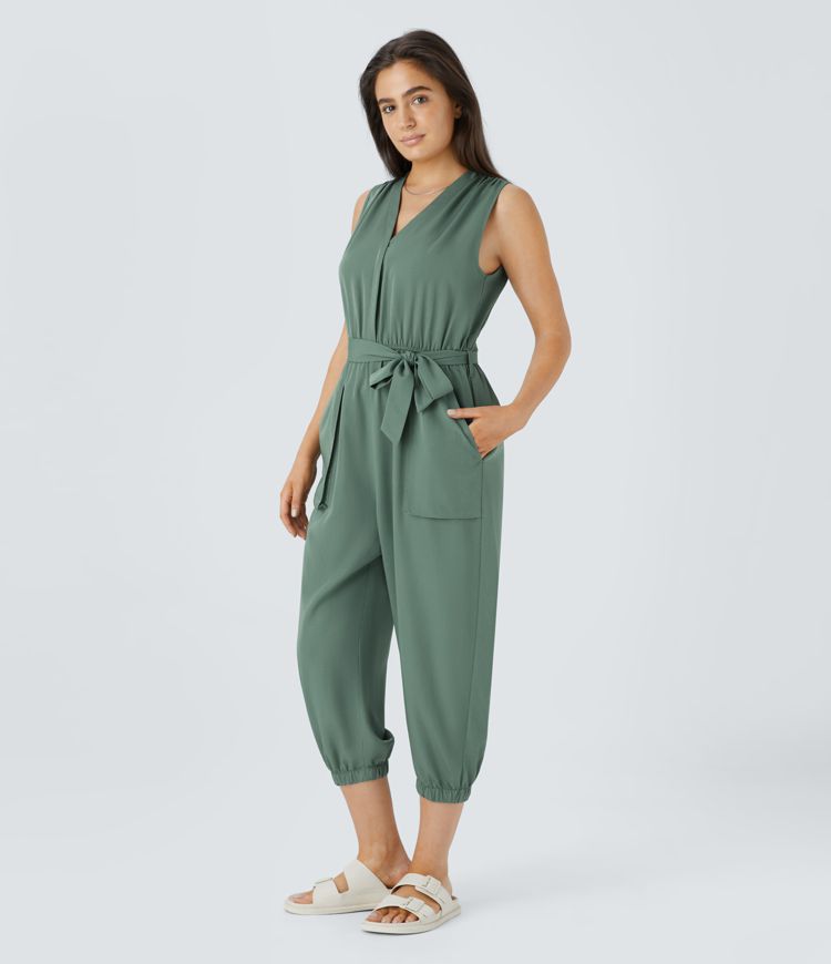 V-neck sleeveless zipper belted jumpsuit with side pocket details in a casual style.
