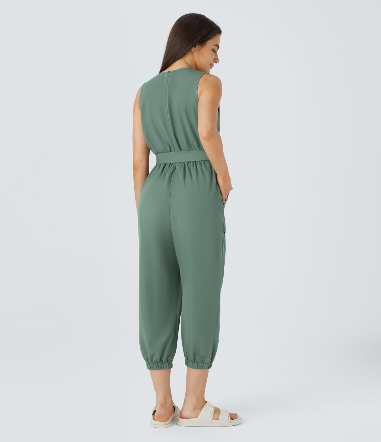 V-neck sleeveless zipper belted jumpsuit with side pocket details in a casual style.