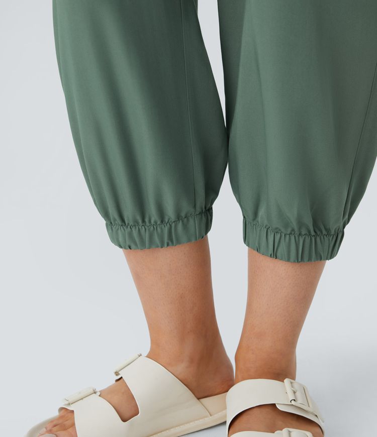 V-neck sleeveless zipper belted jumpsuit with side pocket details in a casual style.