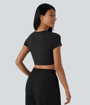 Top sportivo corto SoftlyZero™ con bordo incrociato