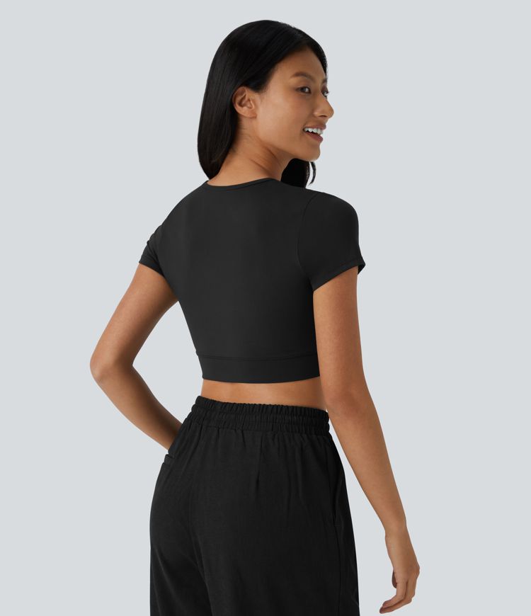 Top sportivo corto SoftlyZero™ con bordo incrociato