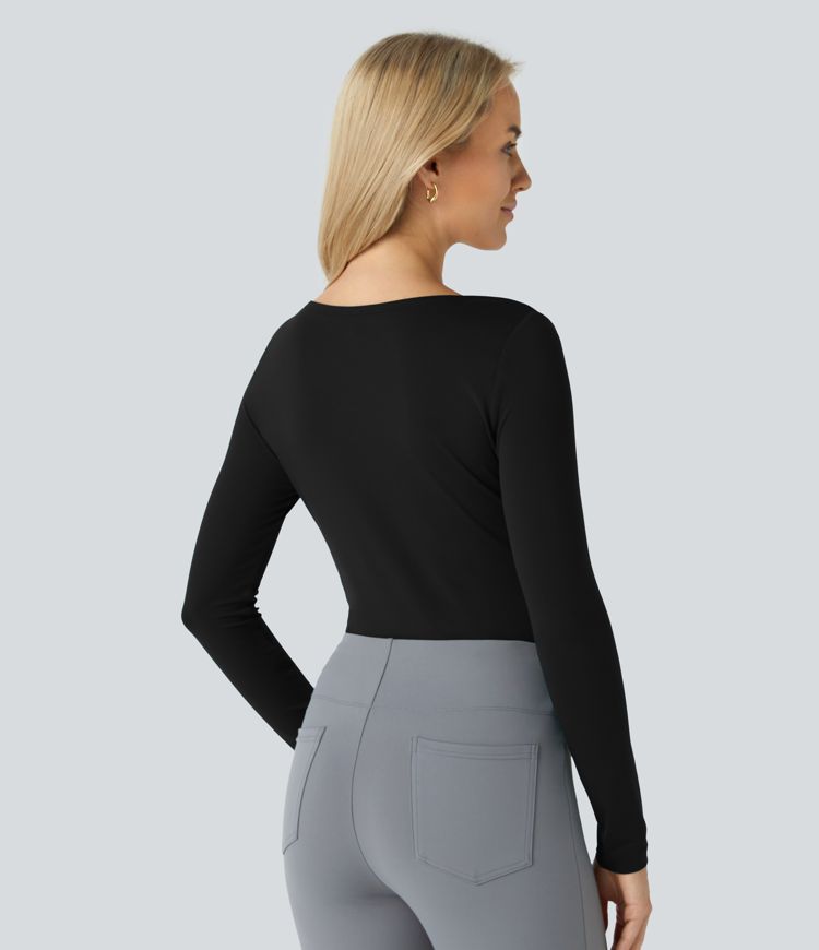 Top asymétrique à manches longues et ourlet arrondi