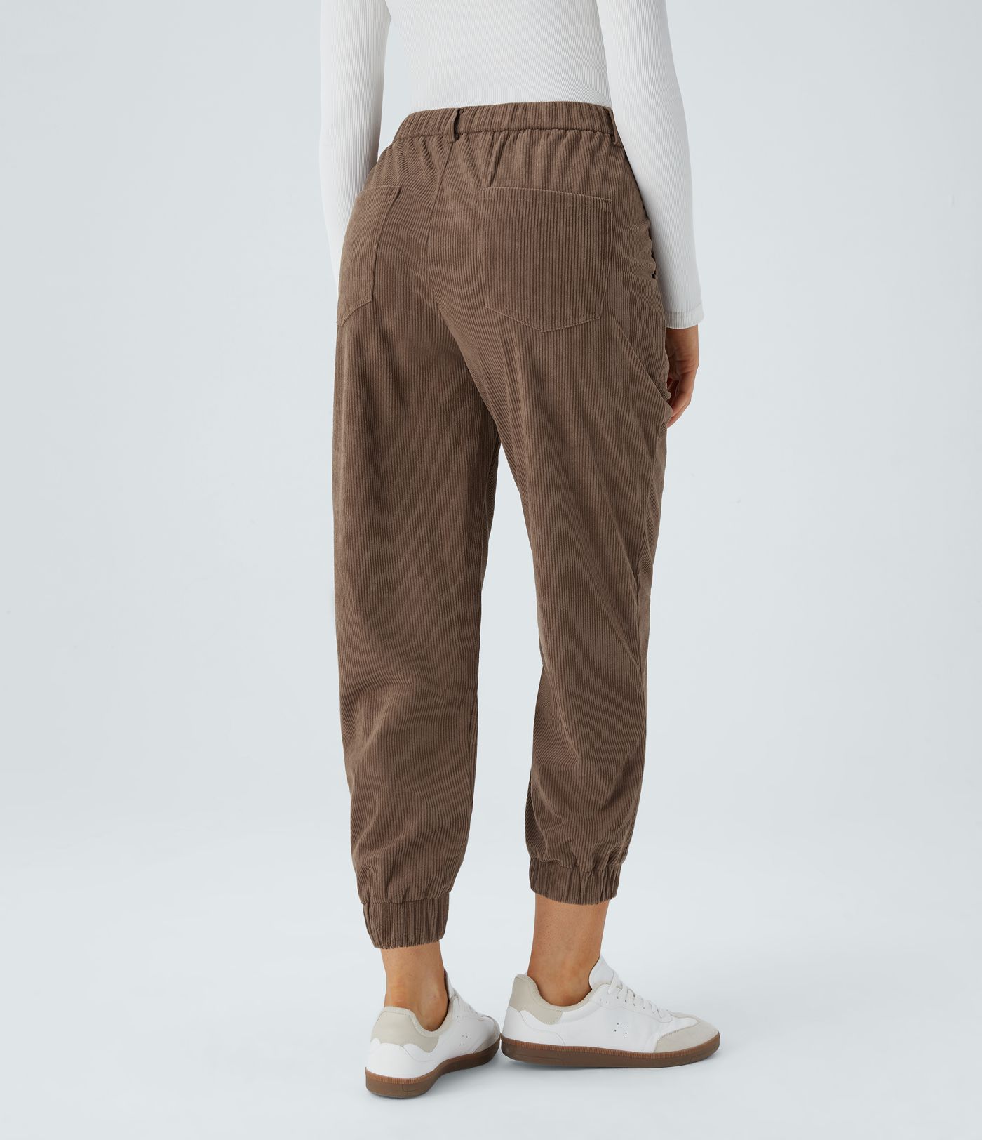 Casual corduroy jogger pants with mid waist, button, zipper, and multiple pockets