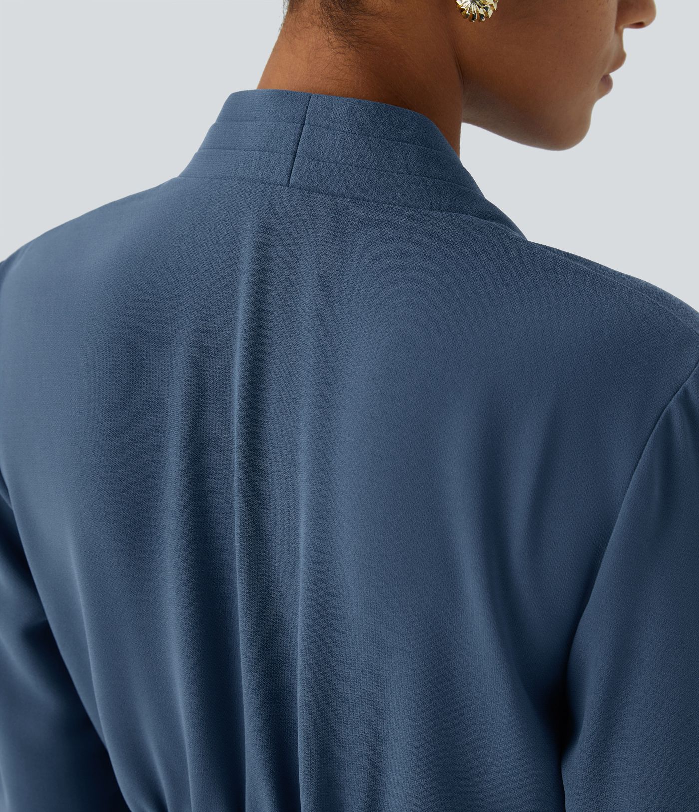 Wrap-front work blouse with V-neckline, ruffles, long sleeves and a slit.