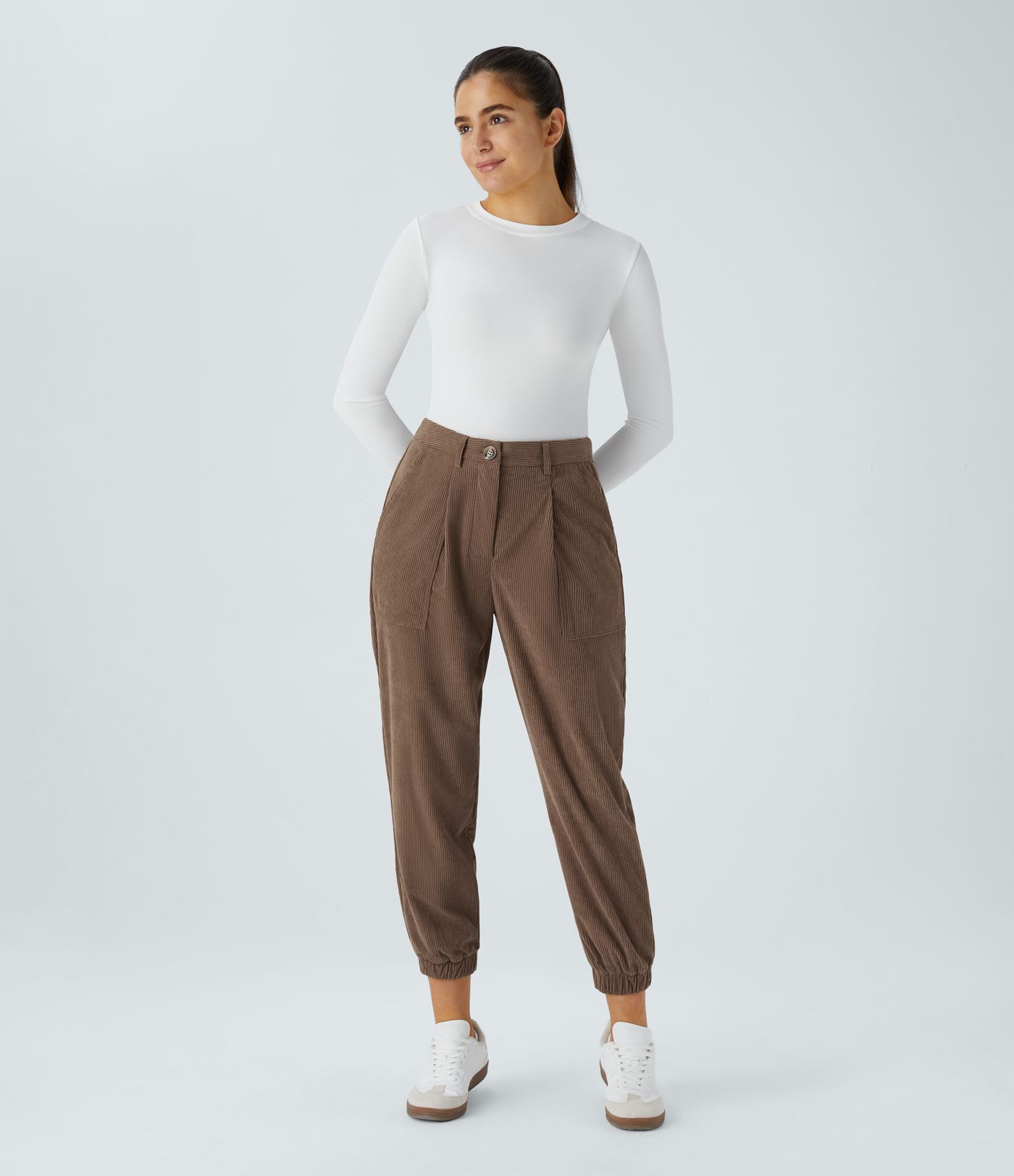 Casual corduroy jogger pants with mid waist, button, zipper, and multiple pockets