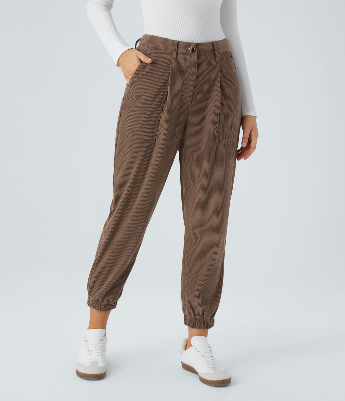 Casual corduroy jogger pants with mid waist, button, zipper, and multiple pockets