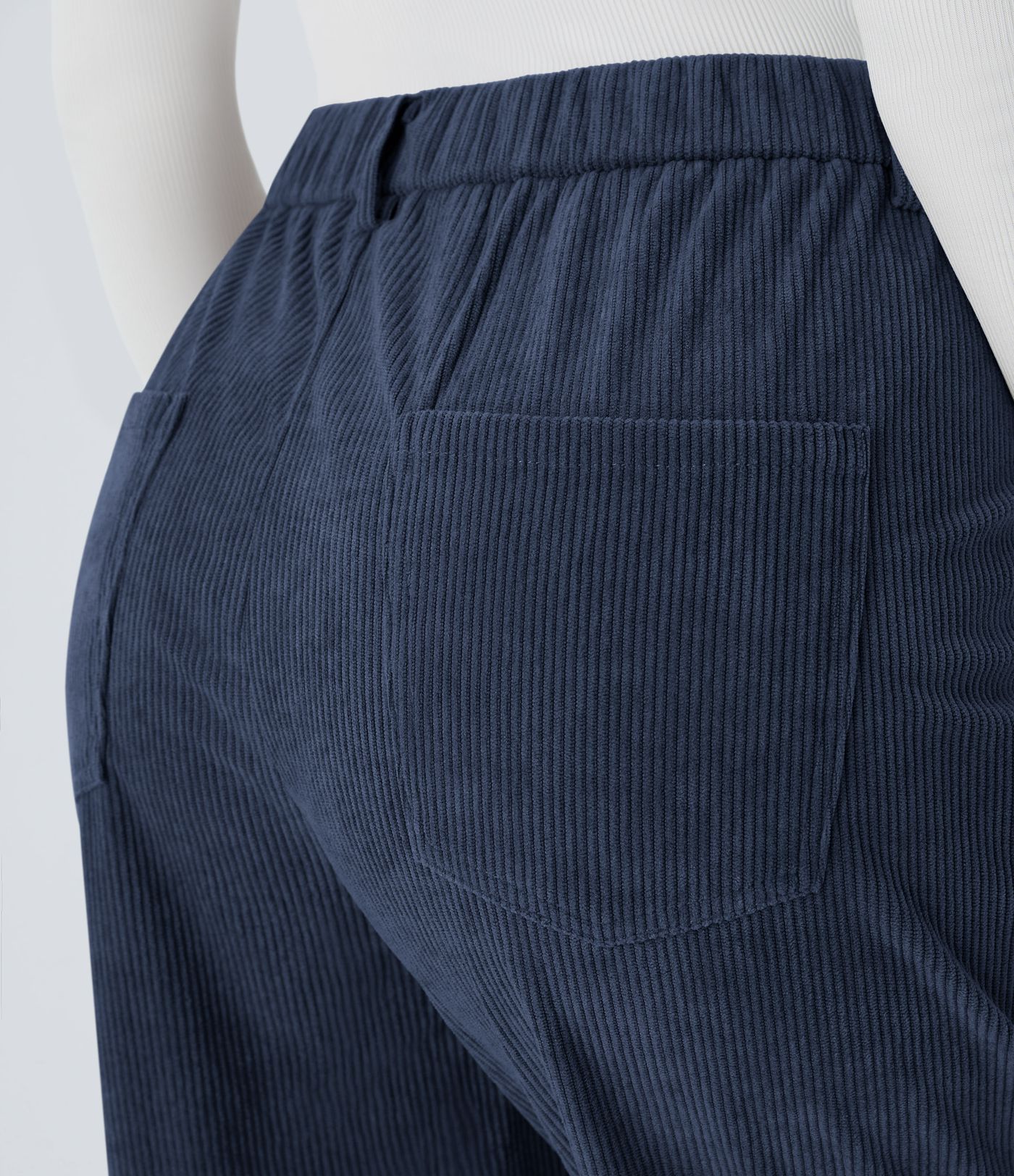 Casual corduroy jogger pants with mid-rise waist, button, zipper, and multiple pockets