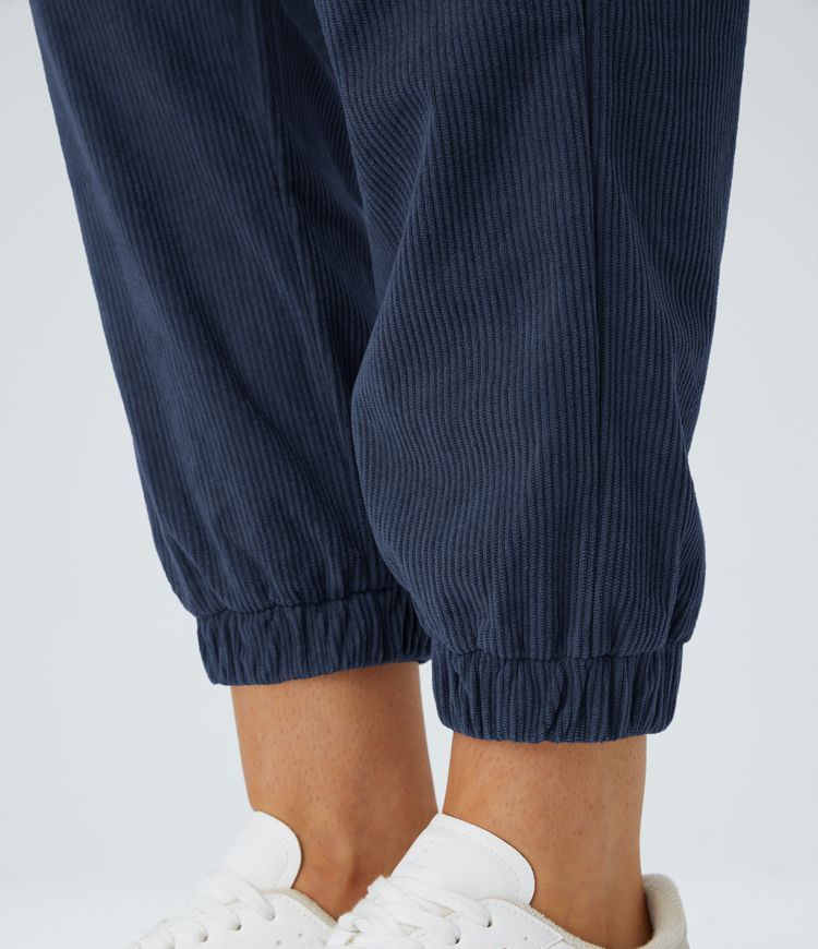Casual corduroy jogger pants with mid-rise waist, button, zipper, and multiple pockets