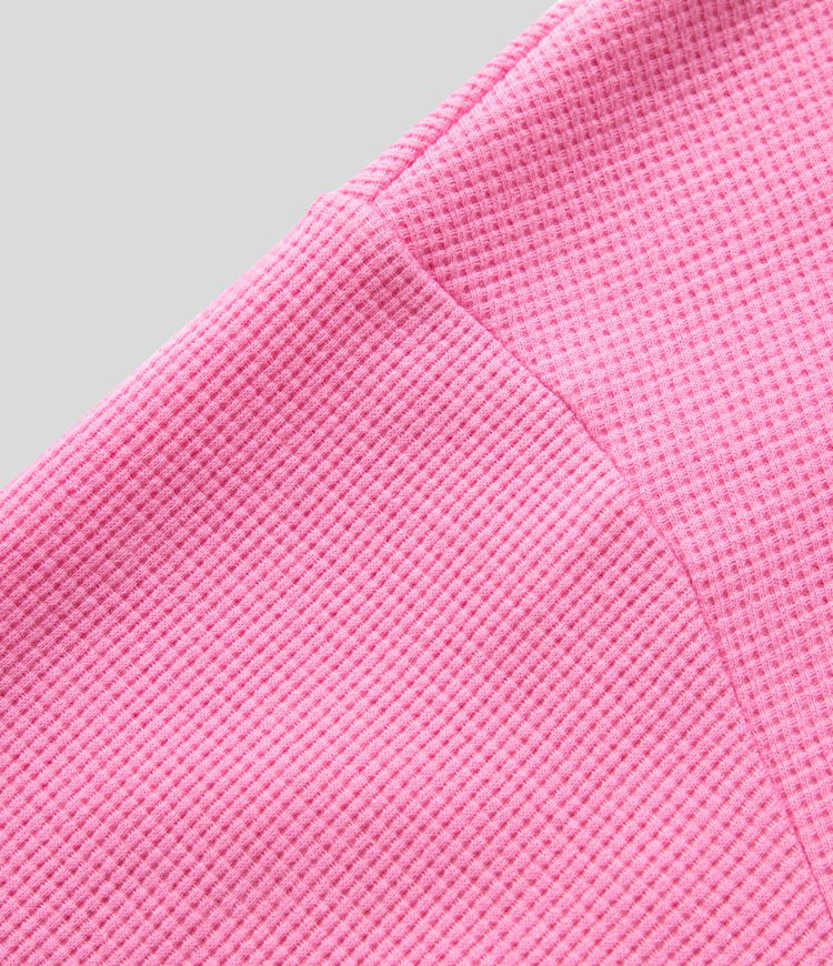 Long-sleeved cotton sweatshirt in oversized fit, V-neck, asymmetric hem, and waffle pattern