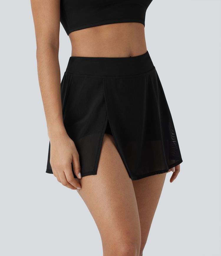 High-waisted yoga mini skirt with built-in shorts, side pockets, and contrasting mesh panels with slits