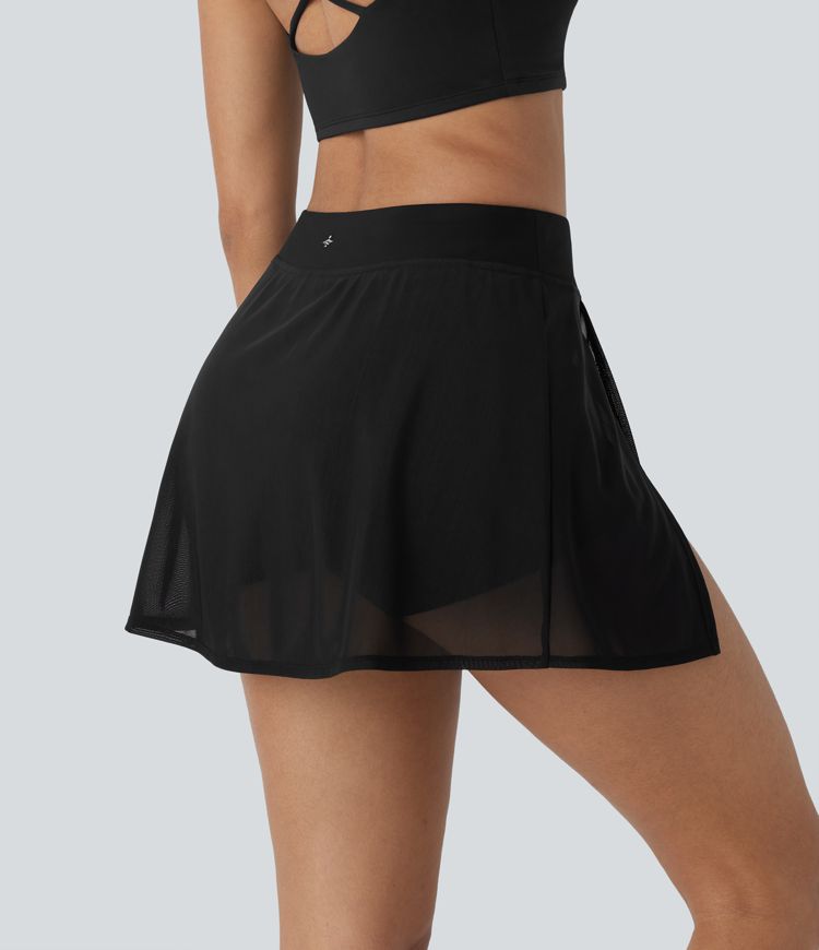 High-waisted yoga mini skirt with built-in shorts, side pockets, and contrasting mesh panels with slits