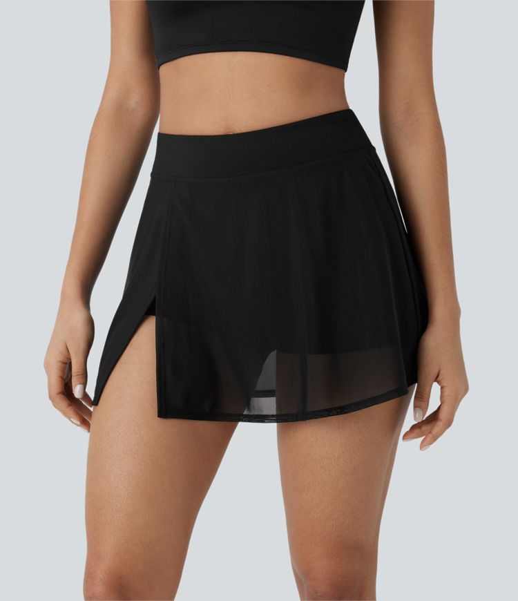 High-waisted yoga mini skirt with built-in shorts, side pockets, and contrasting mesh panels with slits