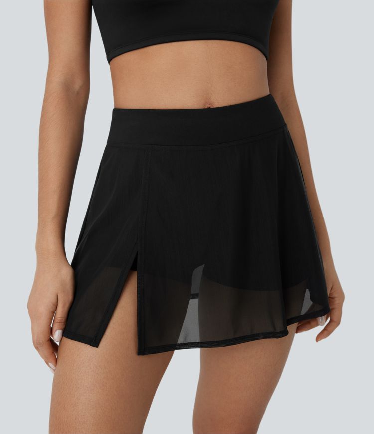 High-waisted yoga mini skirt with built-in shorts, side pockets, and contrasting mesh panels with slits