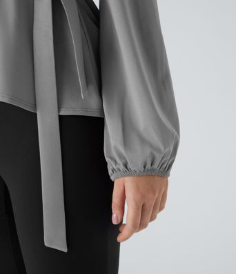 Arbeitsbluse mit Schalkragen, seitlicher Masche und Rüschensaum