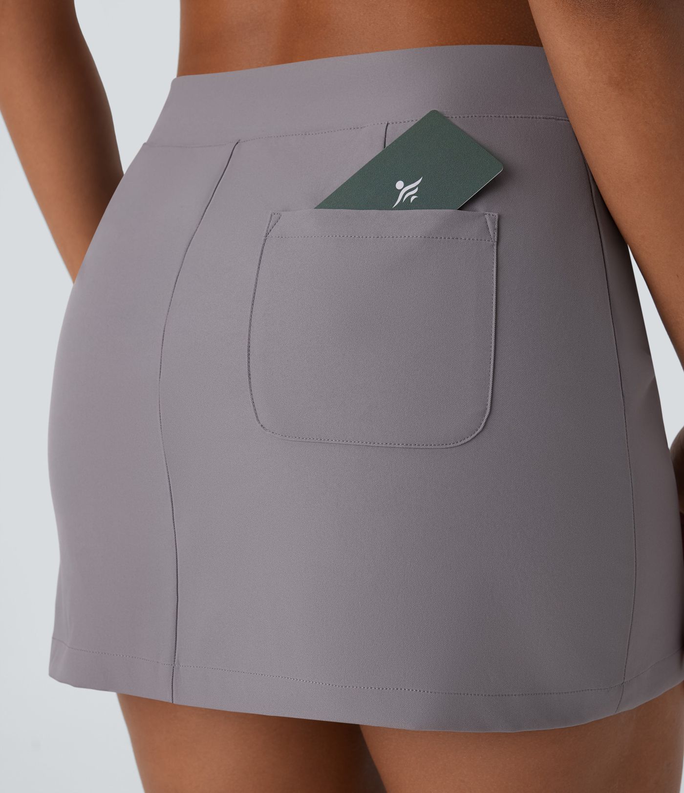 Mini-jupe décontractée en twill déperlante à taille basse avec ceinture en V, fermeture invisible et poche au dos
