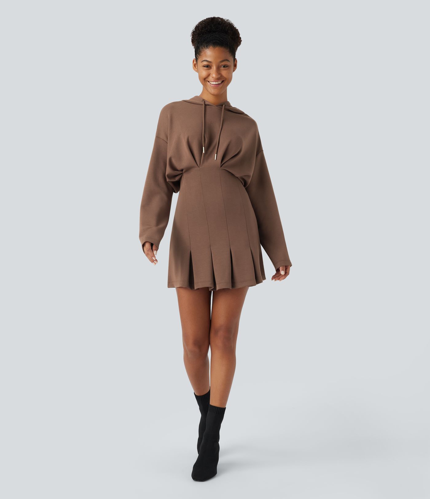 Mini dress with adjustable drawstring, off-the-shoulder design, long sleeves, pleated hem, hip wrap, and hood