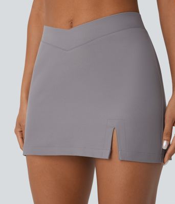 Mini-jupe décontractée en twill déperlante à taille basse avec ceinture en V, fermeture invisible et poche au dos