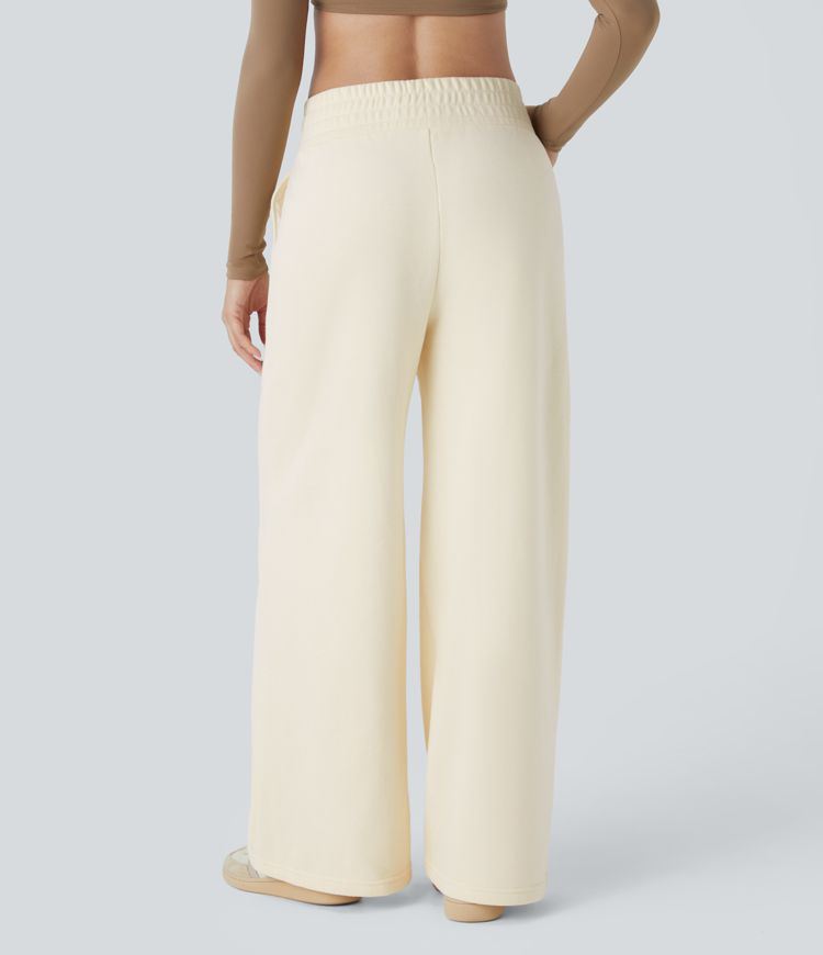 Crossover leisure pants with high waist, side pockets, and wide leg
