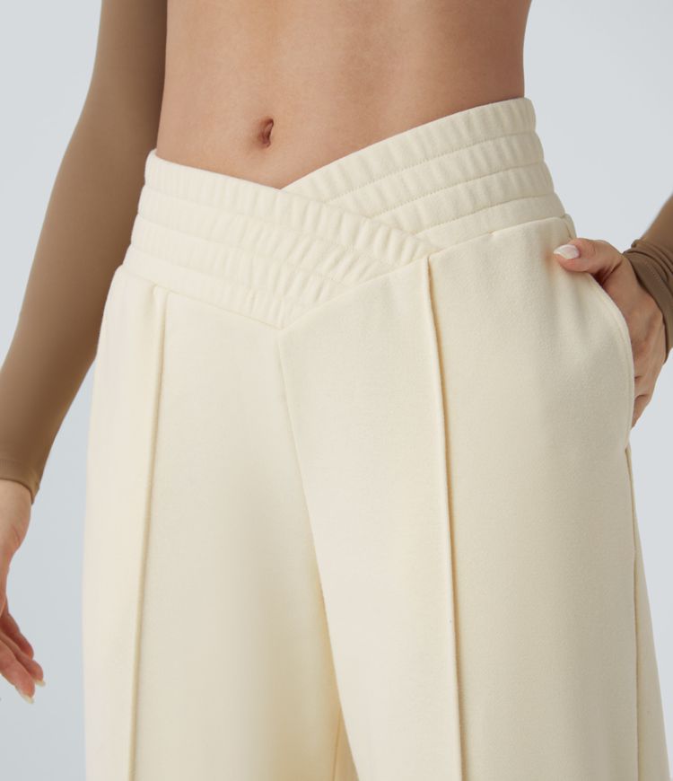 Crossover leisure pants with high waist, side pockets, and wide leg