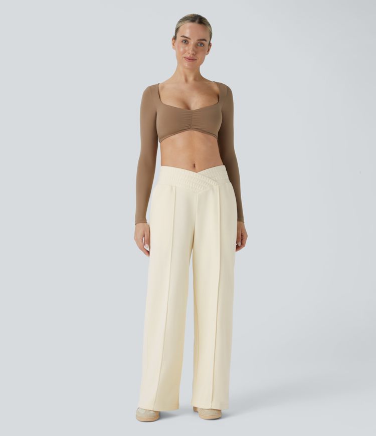 Crossover leisure pants with high waist, side pockets, and wide leg