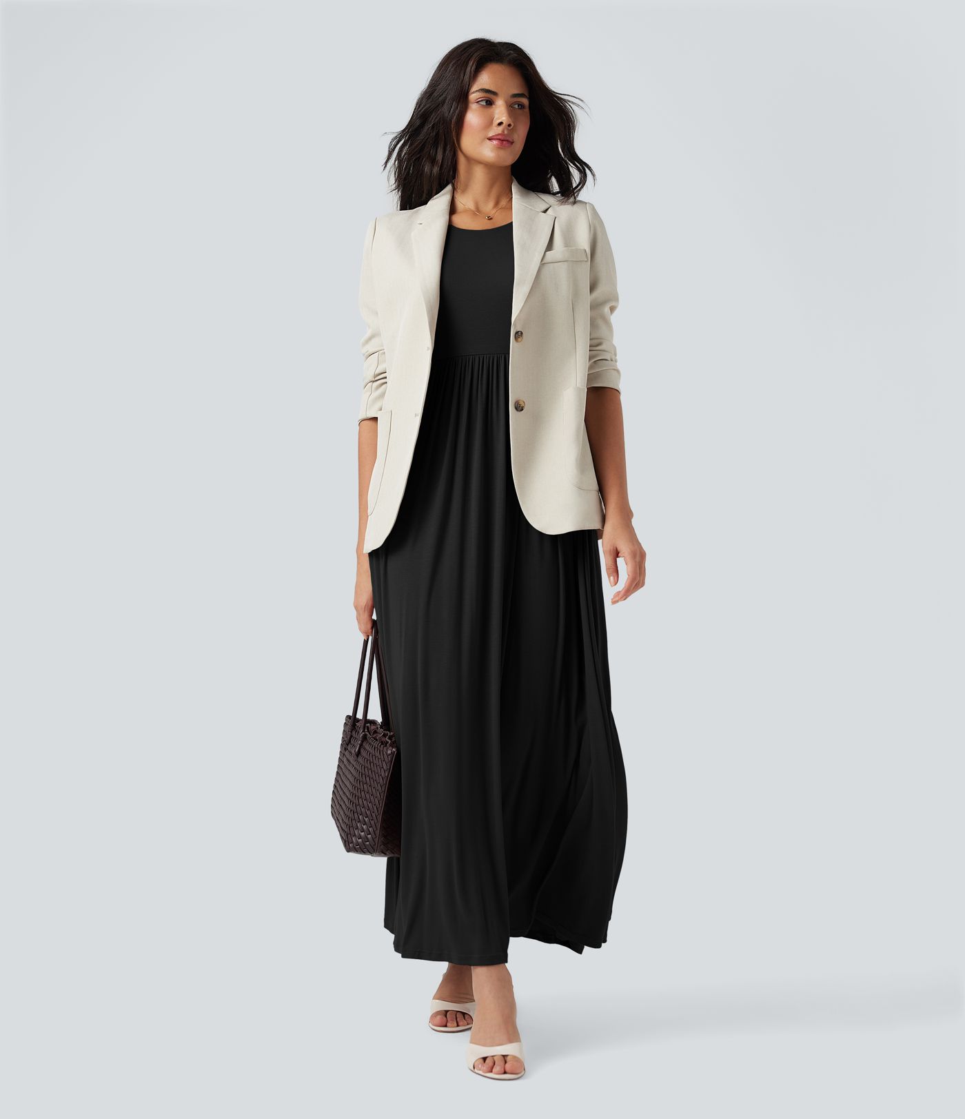 Long, flowy, casual ribbed knit dress with a round neck and three-quarter sleeves, featuring pockets.