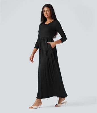 Long, flowy, casual ribbed knit dress with a round neck and three-quarter sleeves, featuring pockets.