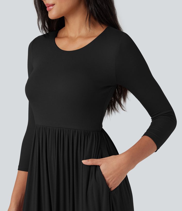 Long, flowy, casual ribbed knit dress with a round neck and three-quarter sleeves, featuring pockets.