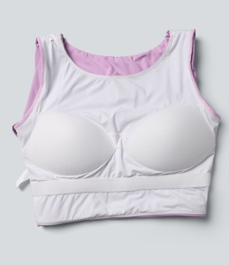 Trumpintas jogos sportinis topas su push-up efektu, formuotais spacer kaušeliais, apvalia iškirpte, ilgomis rankovėmis su nykščių angomis ir kryžminiu dizainu.