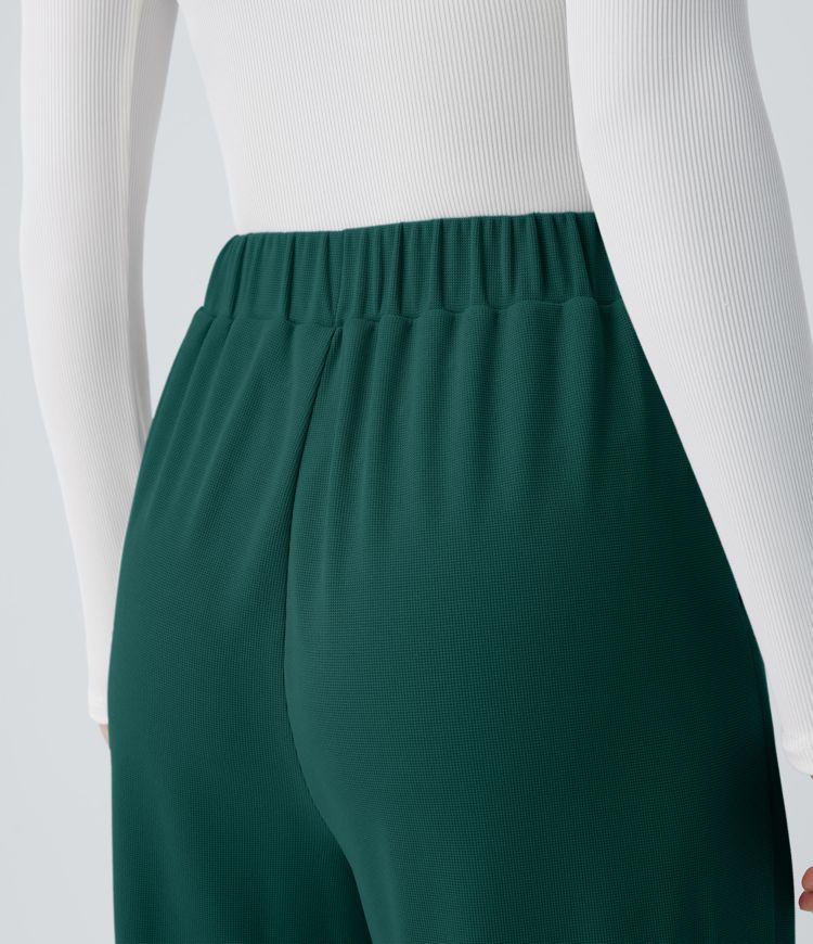 Pantalón tiro alto botón bolsillo lateral plisado pierna ancha