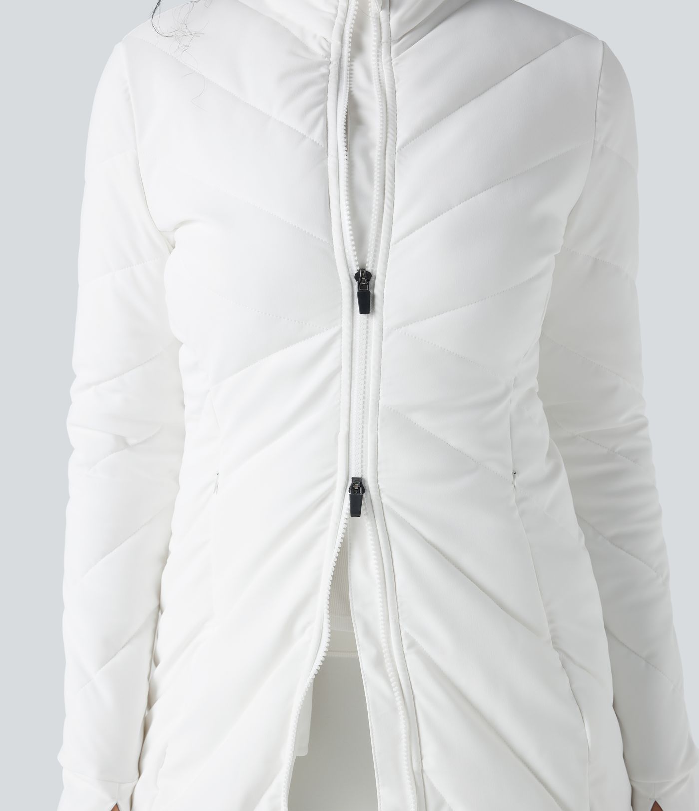 Chaqueta acolchada casual con cuello alto, doble cremallera, orificios para el pulgar y bolsillos.