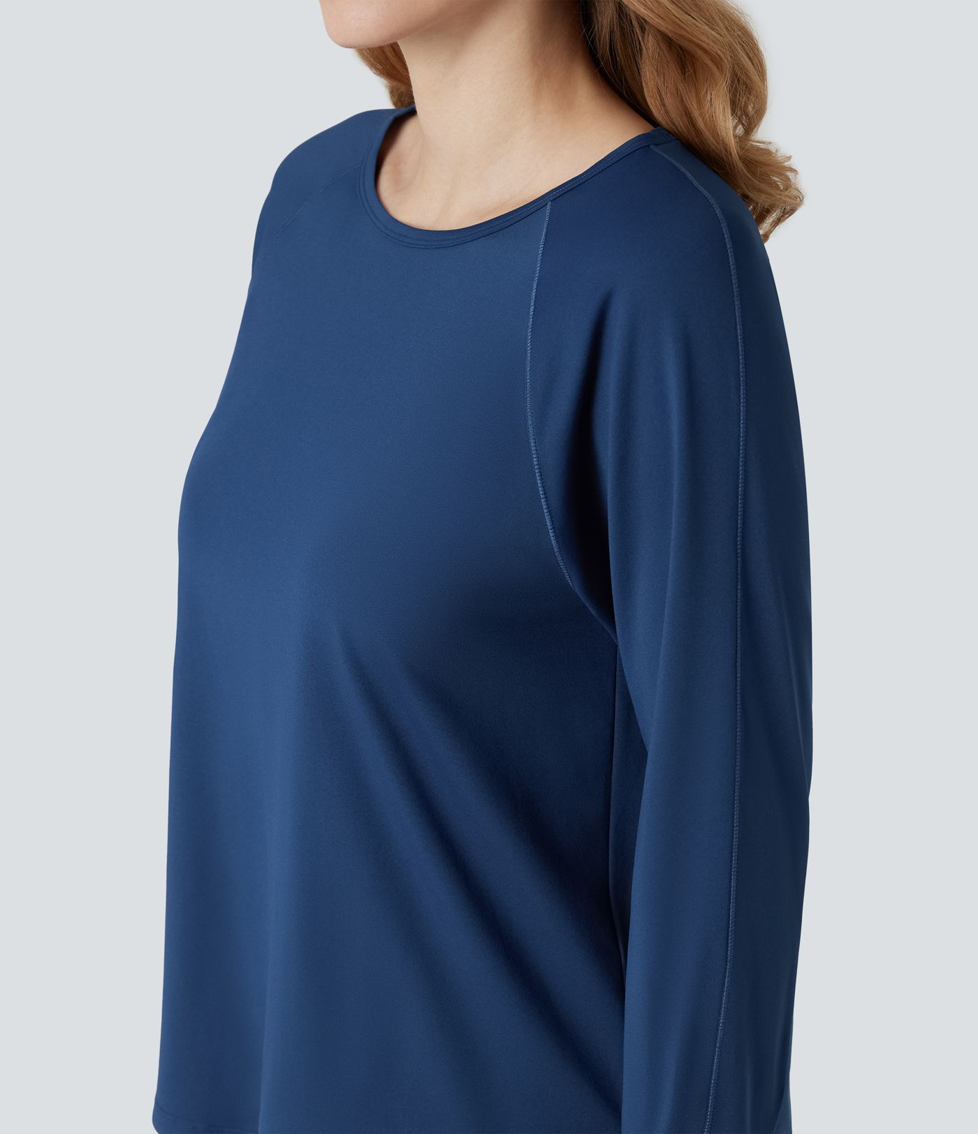 Top de sport à encolure ronde, manches longues, ouverture pour le pouce et empiècements en maille contrastée