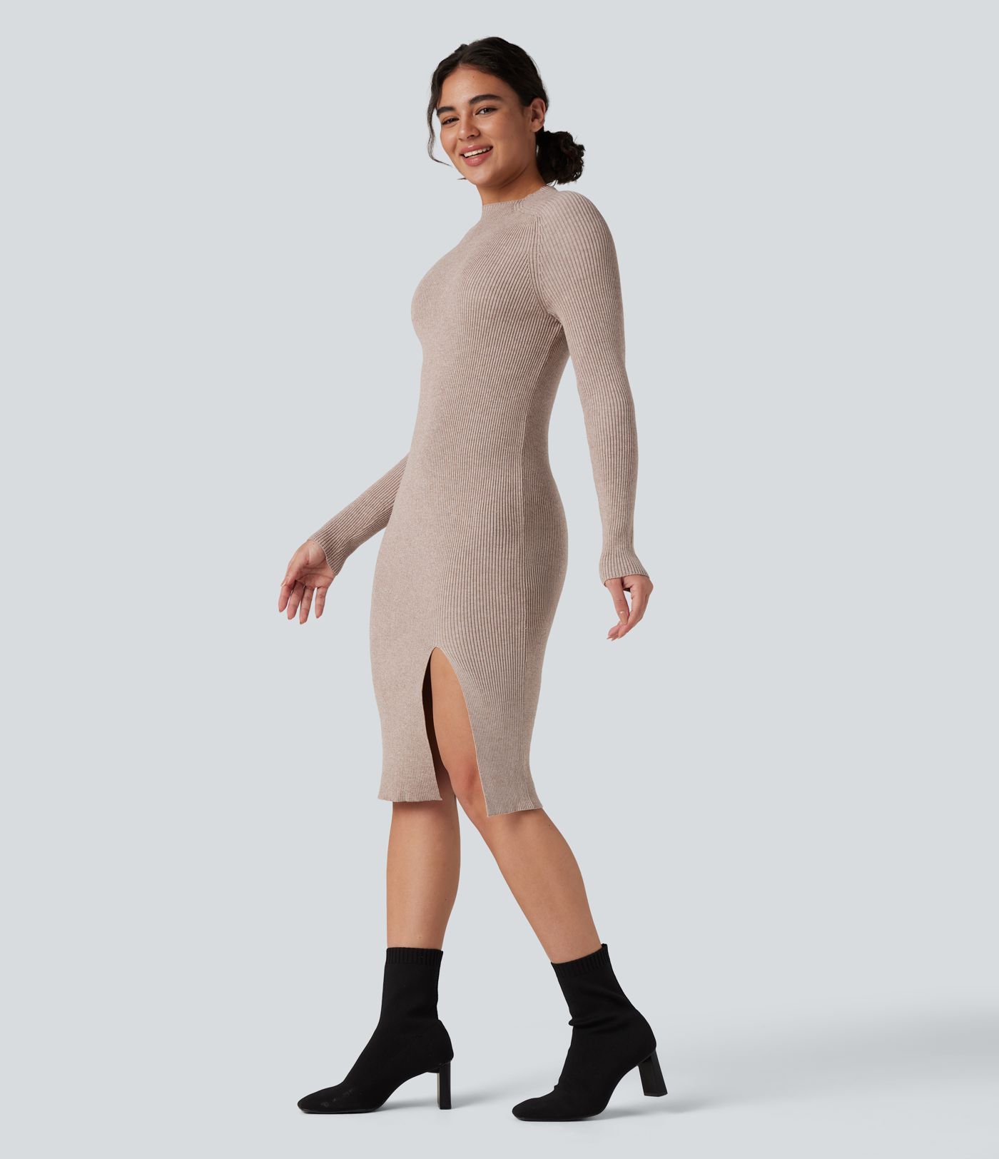 Form-fitting mid-length sweater dress with high neckline, long sleeves, and a slit