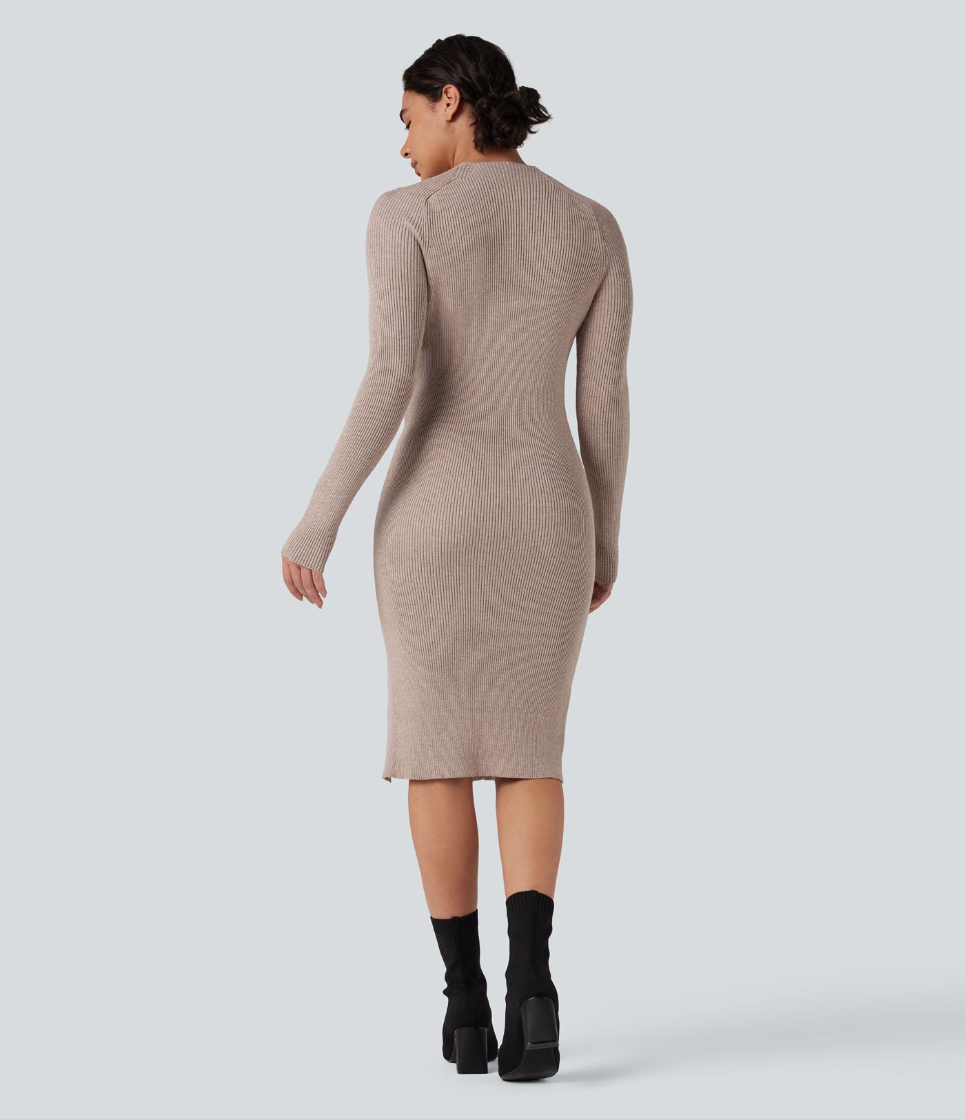 Form-fitting mid-length sweater dress with high neckline, long sleeves, and a slit