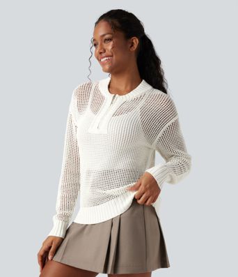 Pull décontracté à col rond avec demi-zip, manches longues et découpes.