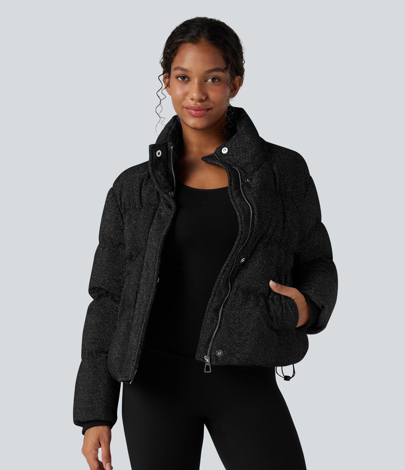 Puffer jacket with a high collar, sparkle effect, and pockets