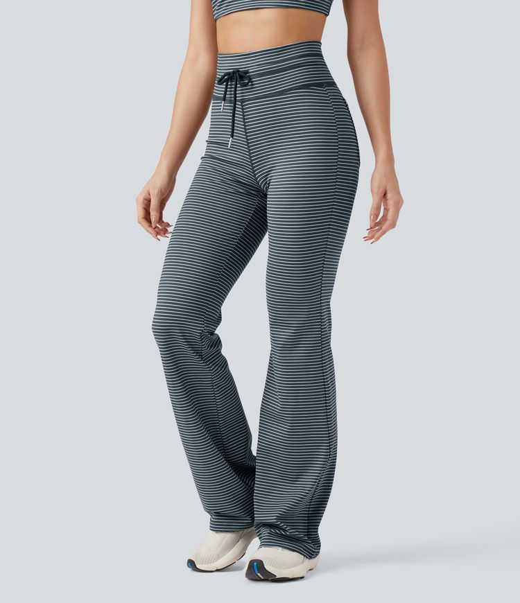 Vysoké sportovní kalhoty s pruhy, stahovací šňůrkou, rozšířeným střihem a kapsami