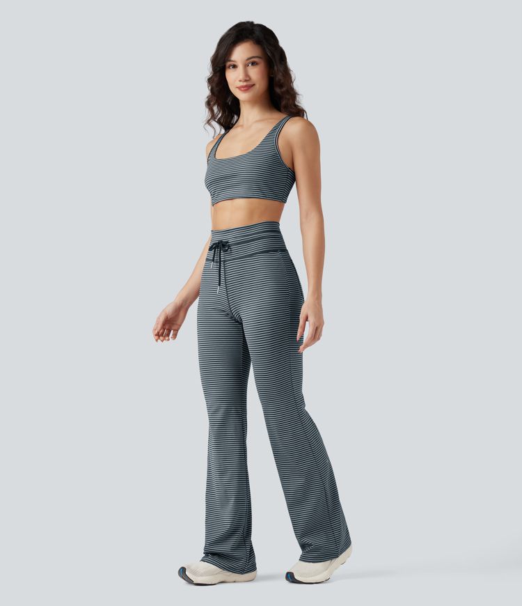 Vysoké sportovní kalhoty s pruhy, stahovací šňůrkou, rozšířeným střihem a kapsami