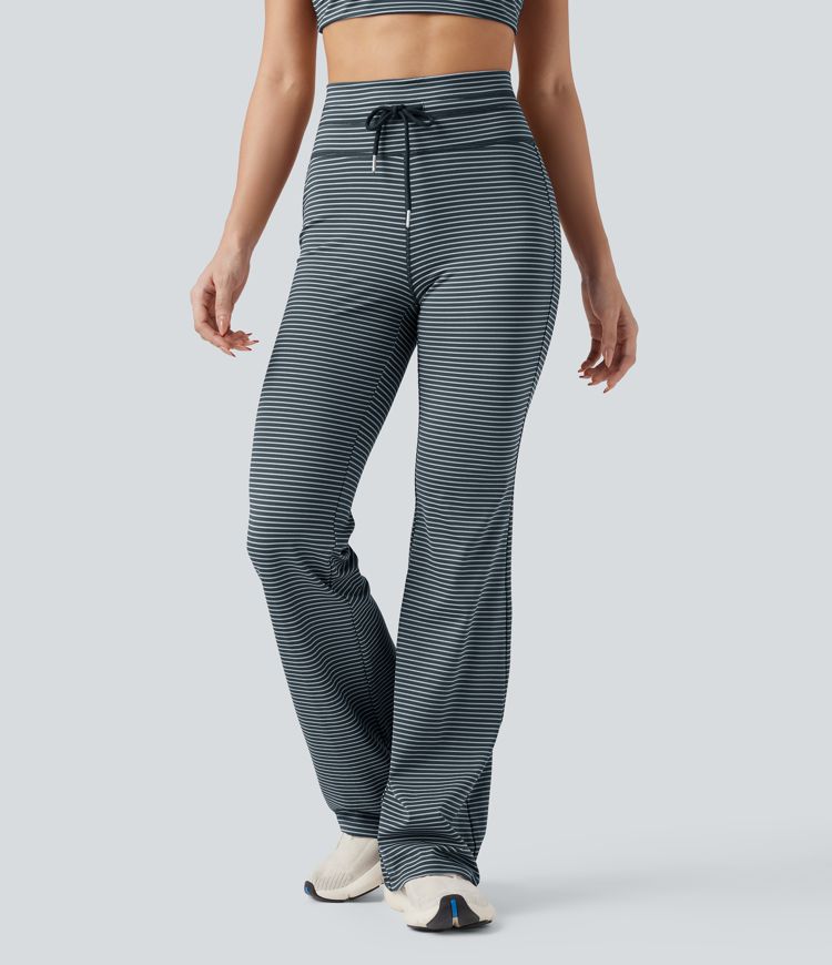 Vysoké sportovní kalhoty s pruhy, stahovací šňůrkou, rozšířeným střihem a kapsami