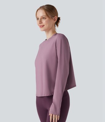 Rygglös, korslagd långärmad yoga- och träningsstopp med tumhål