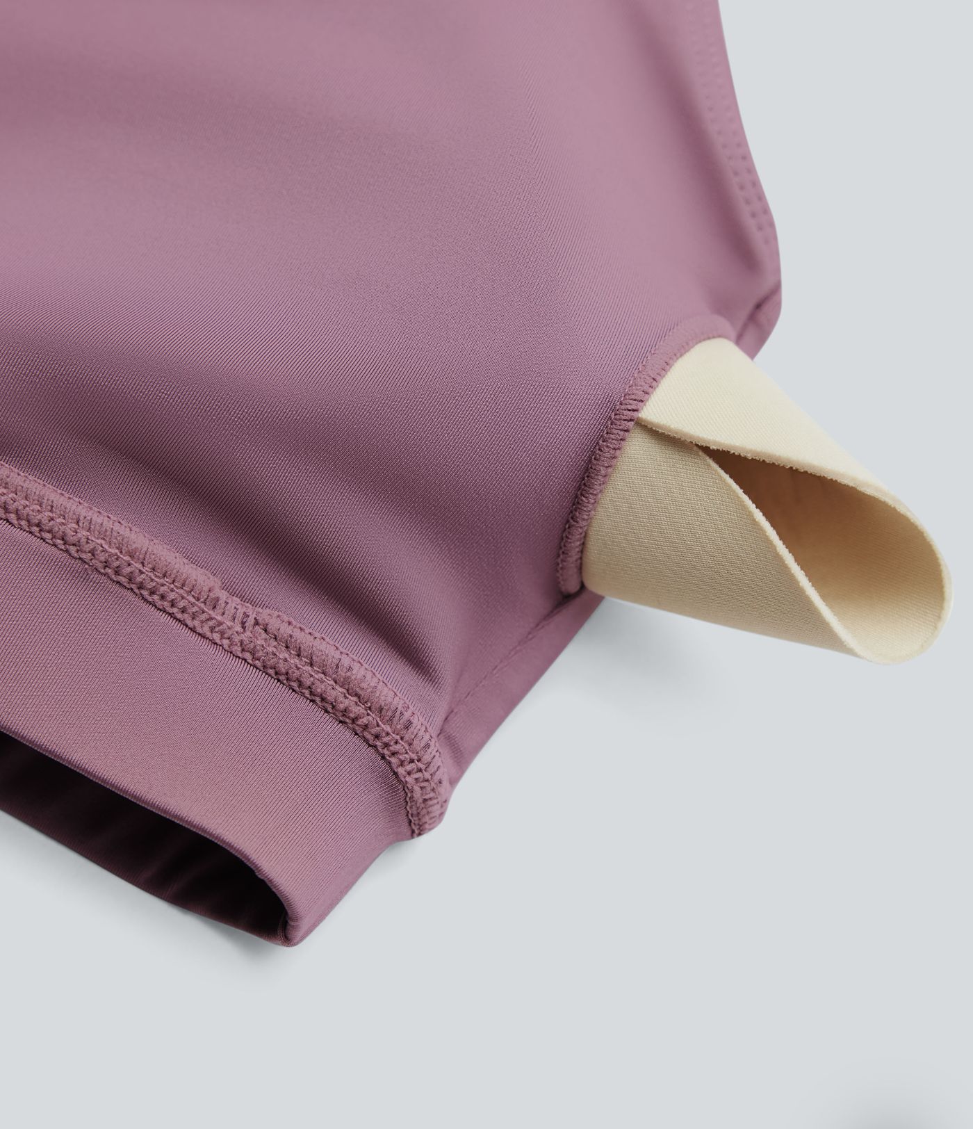 Rygglös, korslagd långärmad yoga- och träningsstopp med tumhål