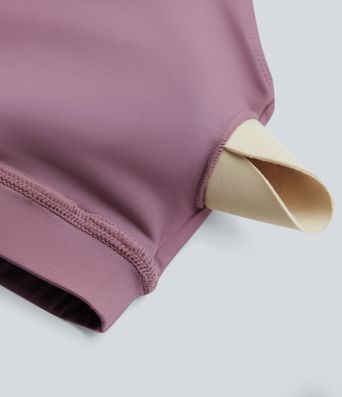 Rygglös, korslagd långärmad yoga- och träningsstopp med tumhål