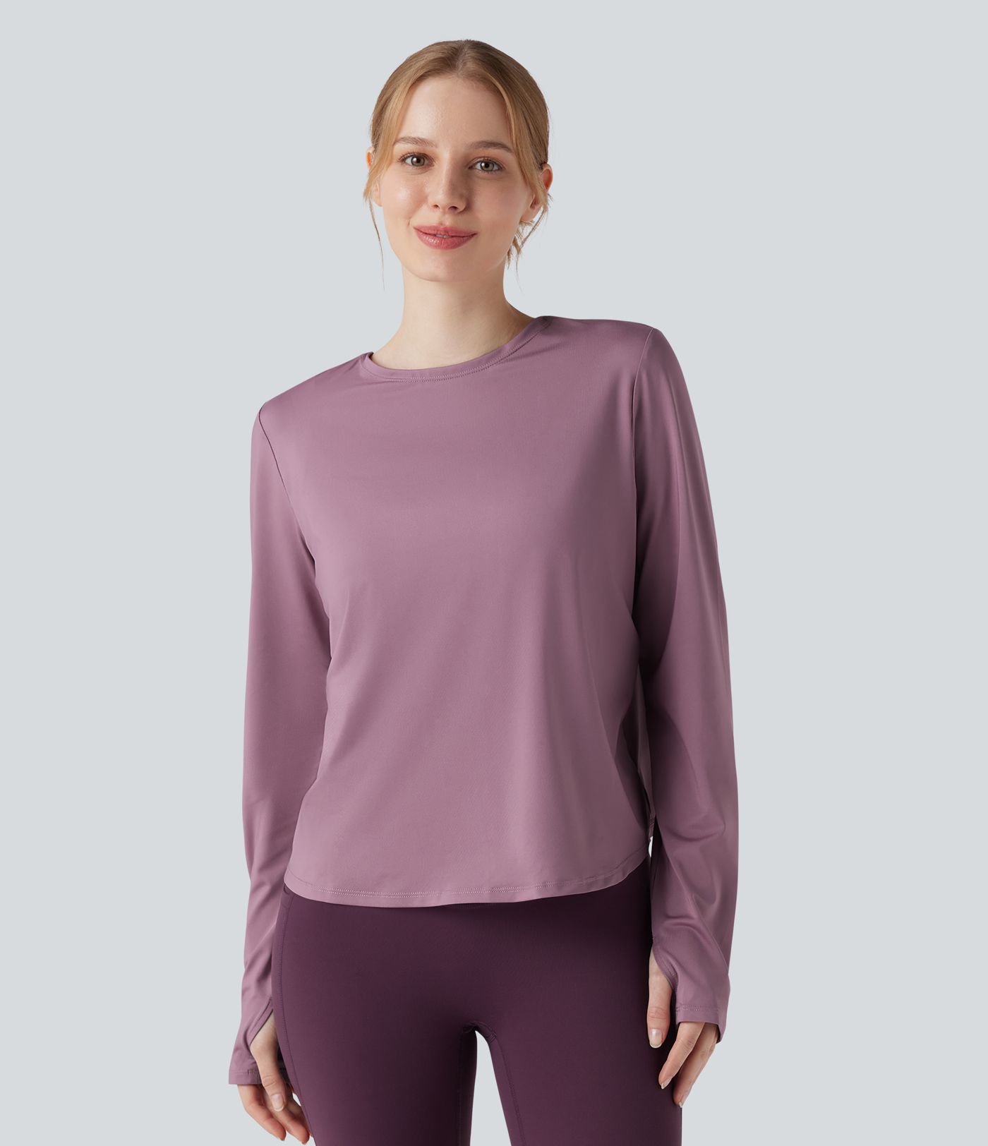 Rygglös, korslagd långärmad yoga- och träningsstopp med tumhål