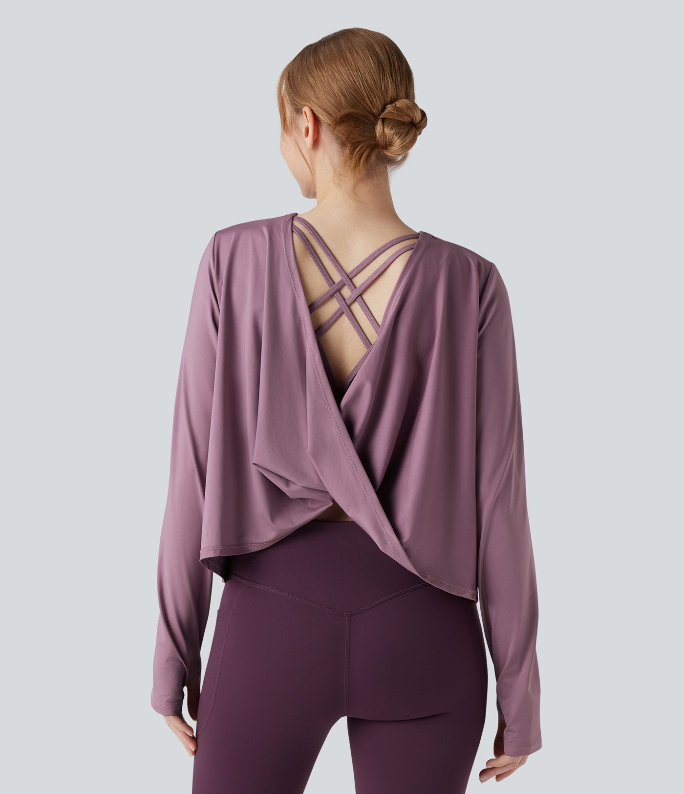 Rygglös, korslagd långärmad yoga- och träningsstopp med tumhål