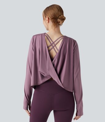 Rygglös, korslagd långärmad yoga- och träningsstopp med tumhål