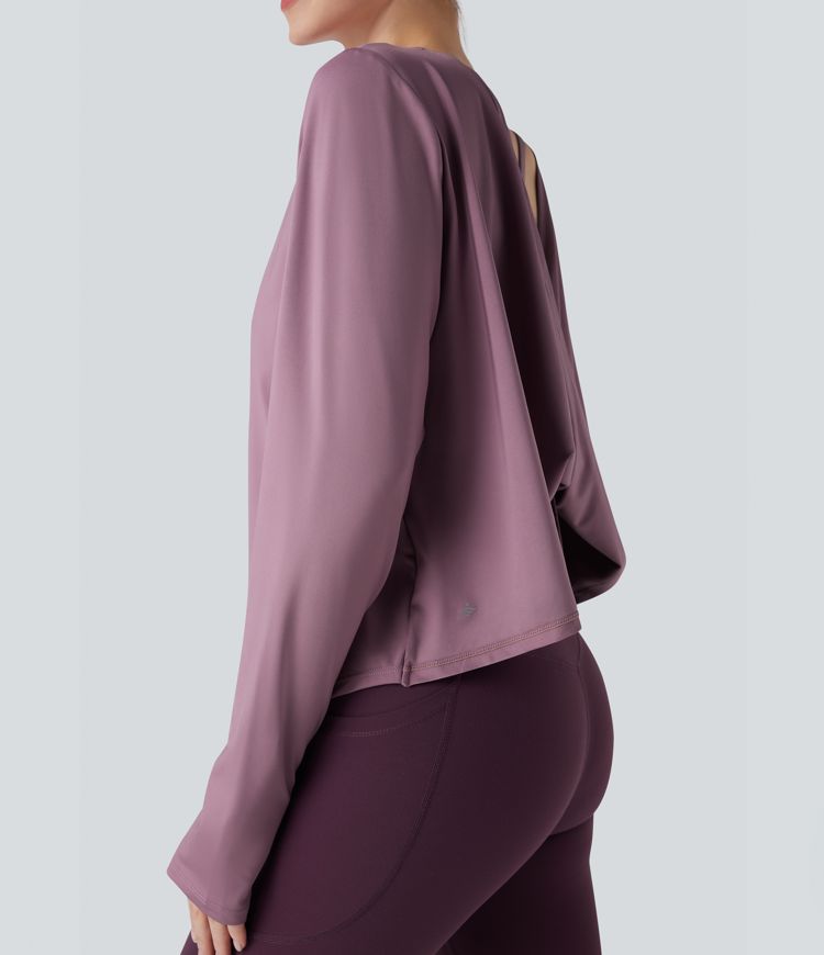 Rygglös, korslagd långärmad yoga- och träningsstopp med tumhål