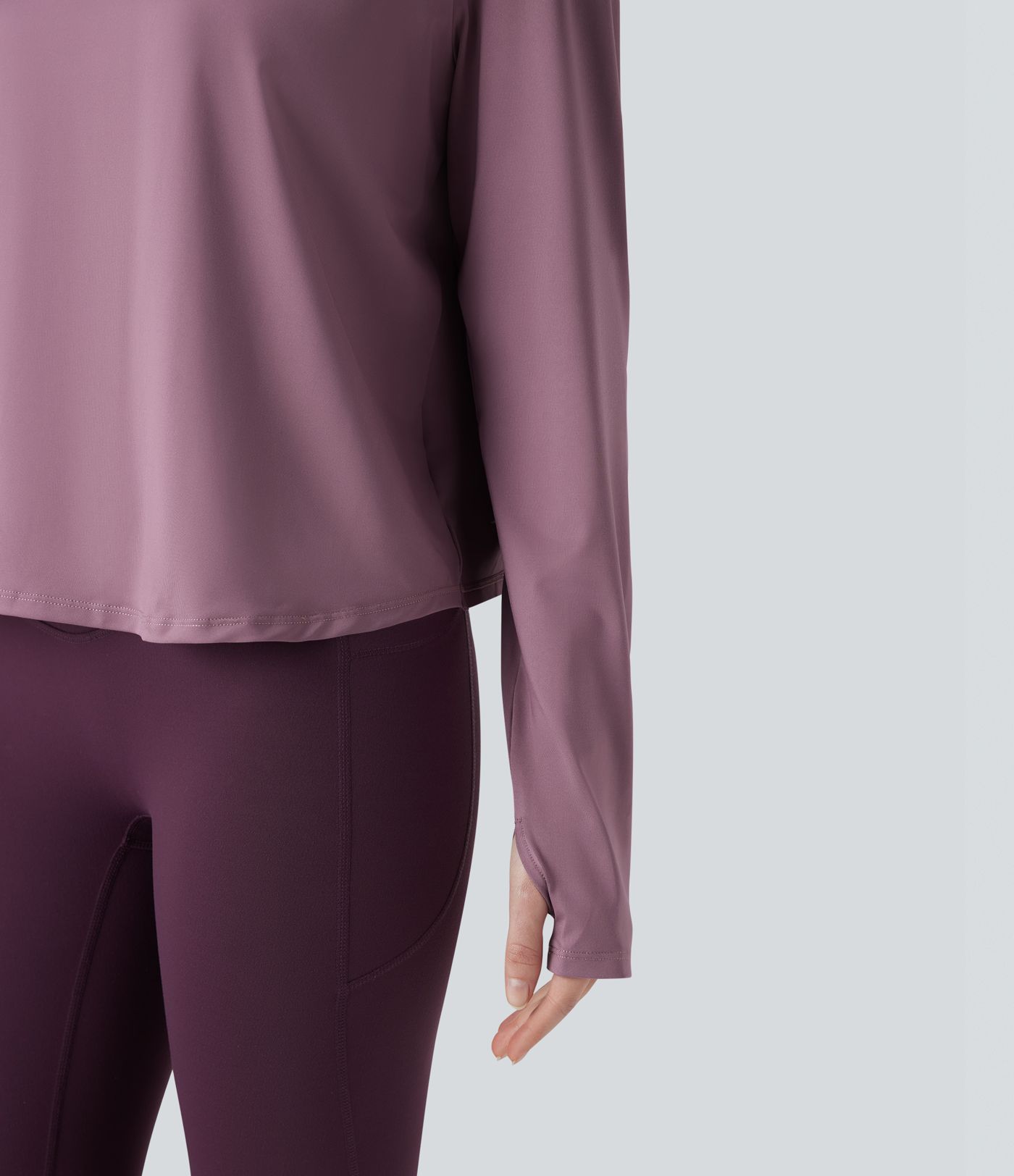 Rygglös, korslagd långärmad yoga- och träningsstopp med tumhål