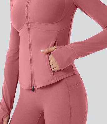 Gilet de yoga Halara UltraSculpt™ à manches longues push-up et taille haute, avec trois poches pour les pouces.